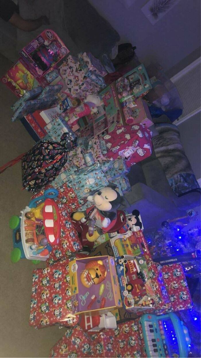 Piles of toys and gift-wrapped presents symbolizing consumerism.