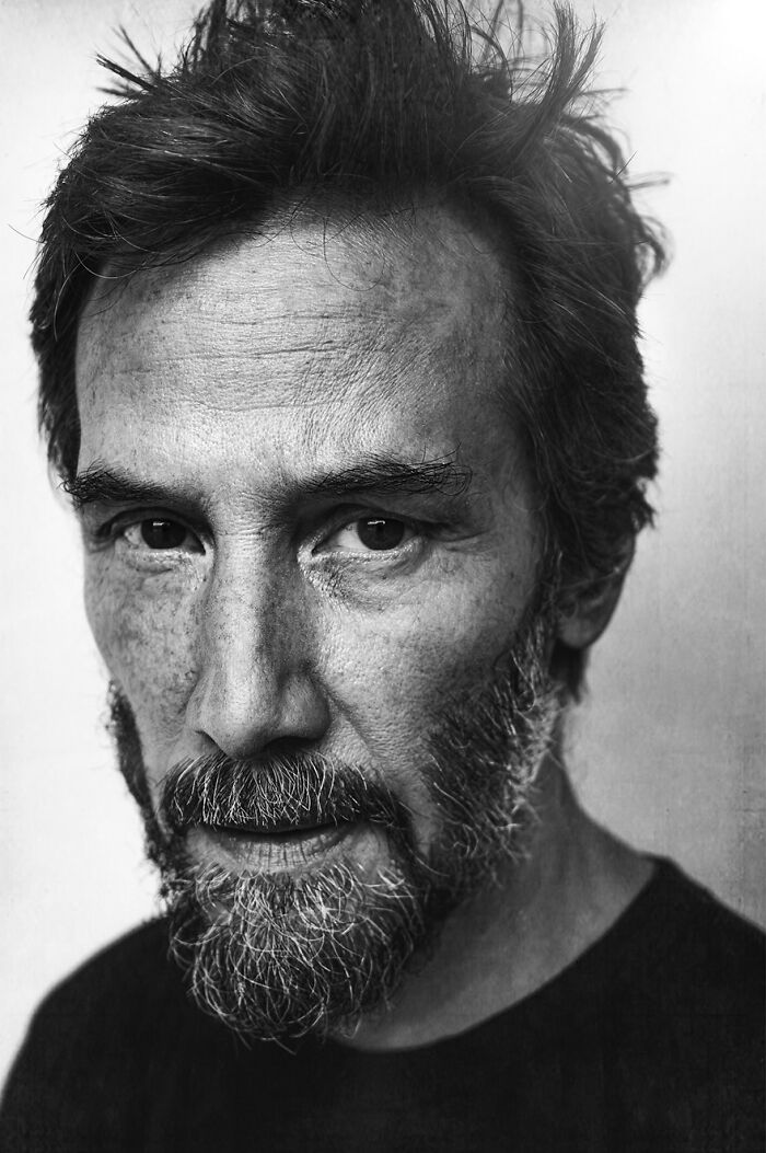 Black and white portrait of a bearded man with intense gaze taken by Lee Jeffries.