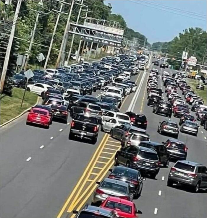 Traffic jam with cars driving on the shoulder, illustrating careless driving behavior.
