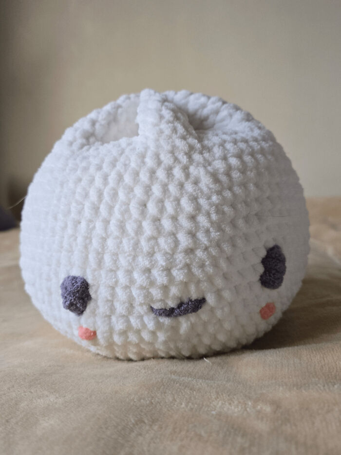 Soft white crochet plush with cute facial features, showcasing a proud crochet enthusiast's handmade project.