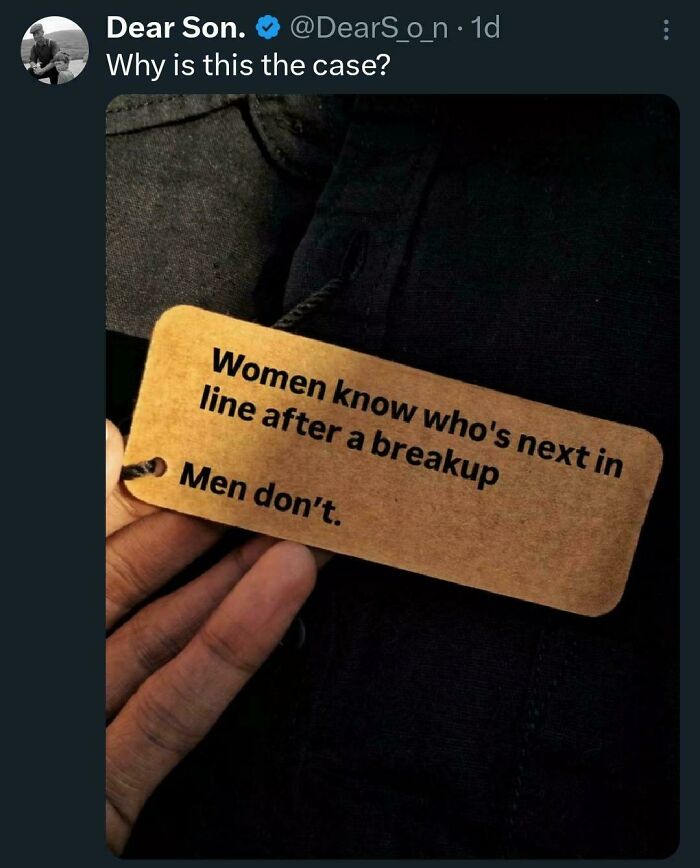 Hand holding note with statement about how girls think post-breakup versus men.