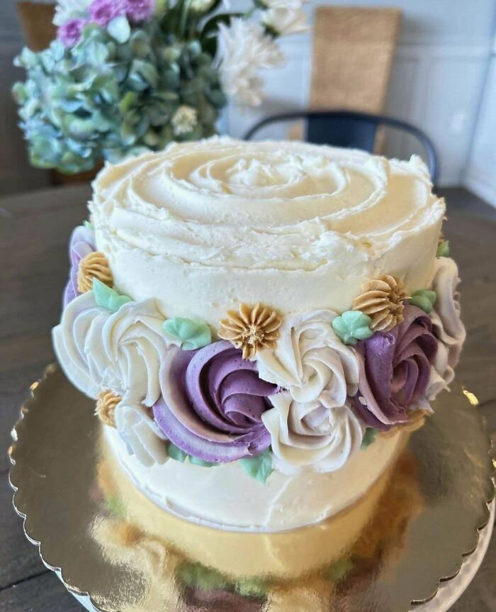 Beautifully decorated cake with intricate floral designs, showcasing a baker's culinary creativity at a whole other level.