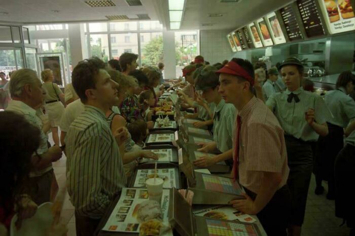 People lined up in a busy fast-food restaurant, showcasing fascinating historical pics from a past era.