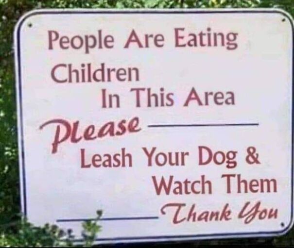 Weird sign with absurd wording advising to leash dogs and watch them in the area.
