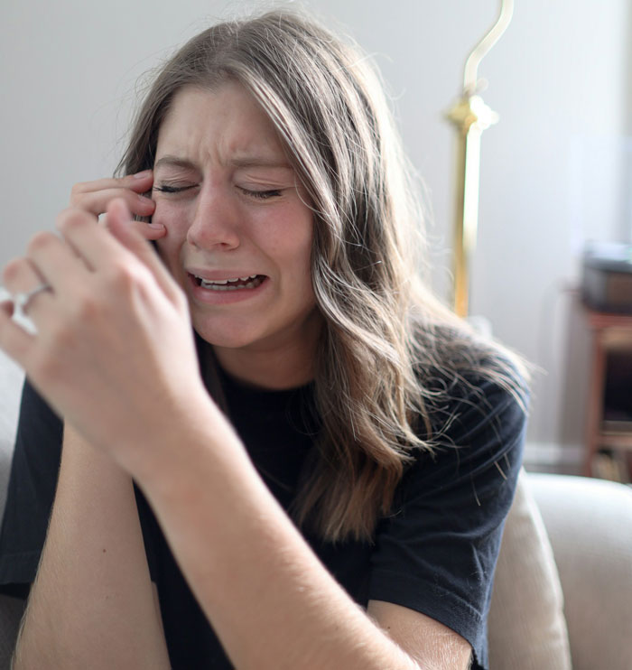 Teen girl crying, overwhelmed after family confrontation about stepdad accusations. Teen girl crying, overwhelmed after family confrontation about stepdad accusations.