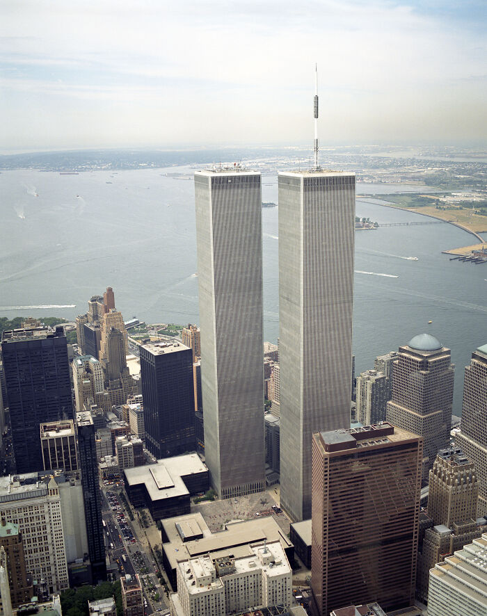 Aerial view of the World Trade Center towers in 1973 with the cityscape and ocean in the background.
