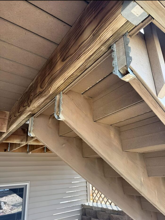 Uneven wooden staircase with misaligned beams, an example of funny cheap construction fails.