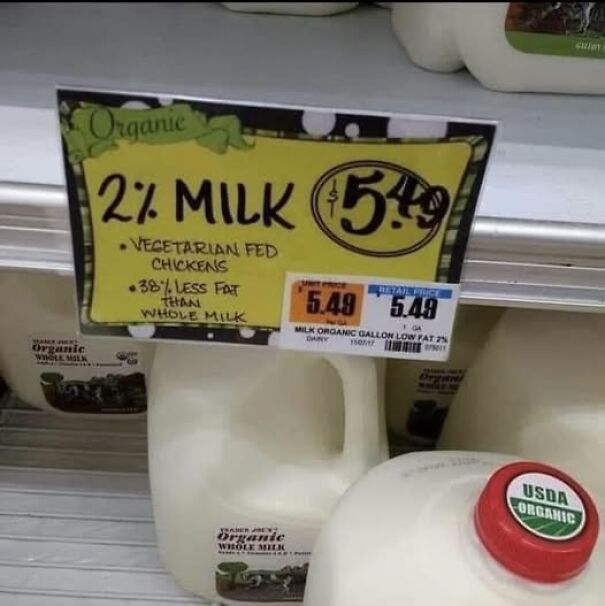 Absurd sign in a store claiming 2% milk comes from vegetarian-fed chickens, priced at $5.49.