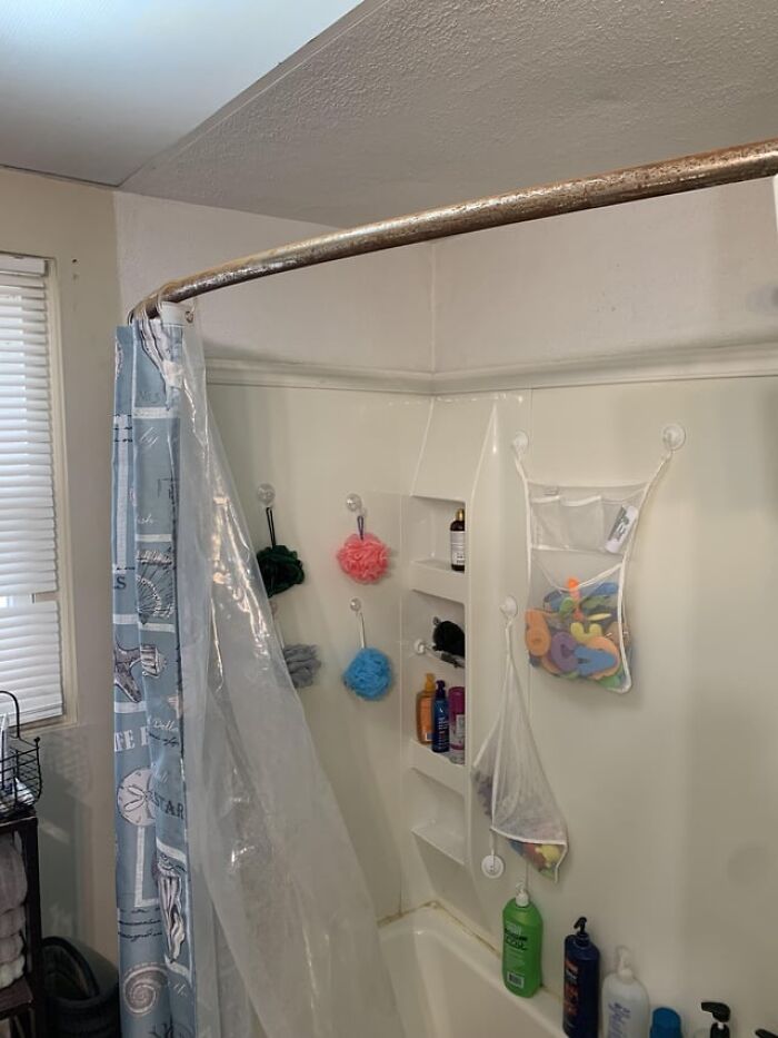 Frugal home hack: Organized bathroom with hanging storage for bath accessories and toiletries, maximizing space efficiently.