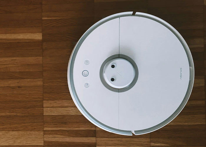 Robot vacuum on hardwood floor, connected to a memorable and unusual 911 call.