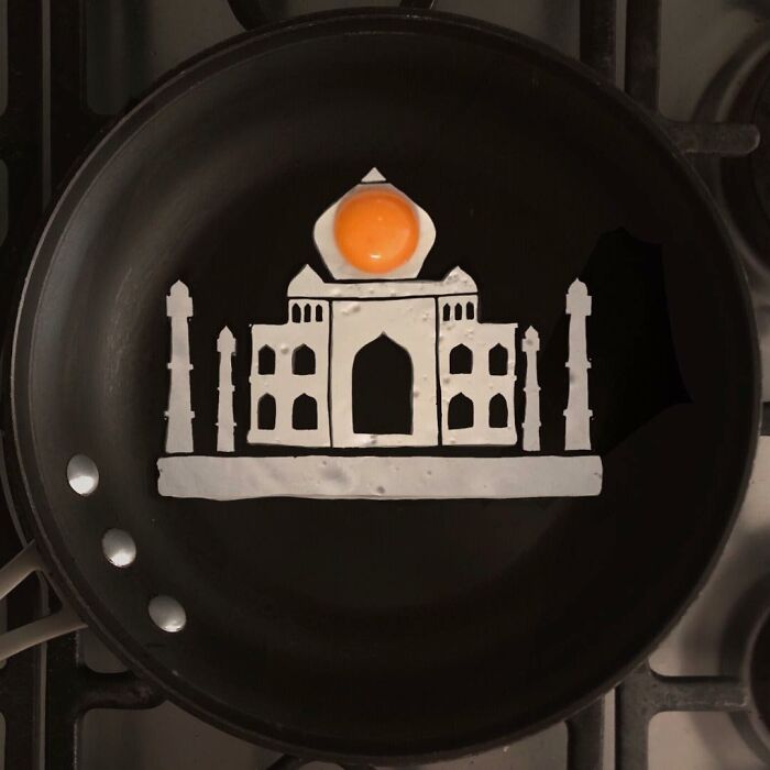 Artist's creative egg frying, shaping egg whites into a Taj Mahal silhouette with yolk as the dome.