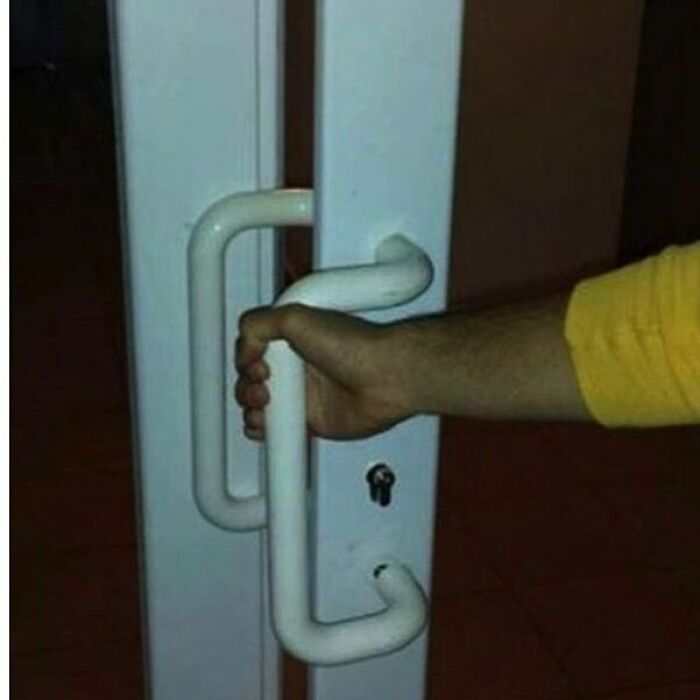 Crooked door handle installation by construction workers, highlighting a funny fail.