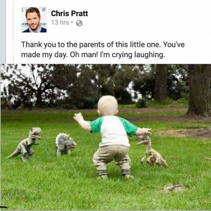 Baby playing with dinosaur toys on grass, capturing a prehistoric sense of humor.