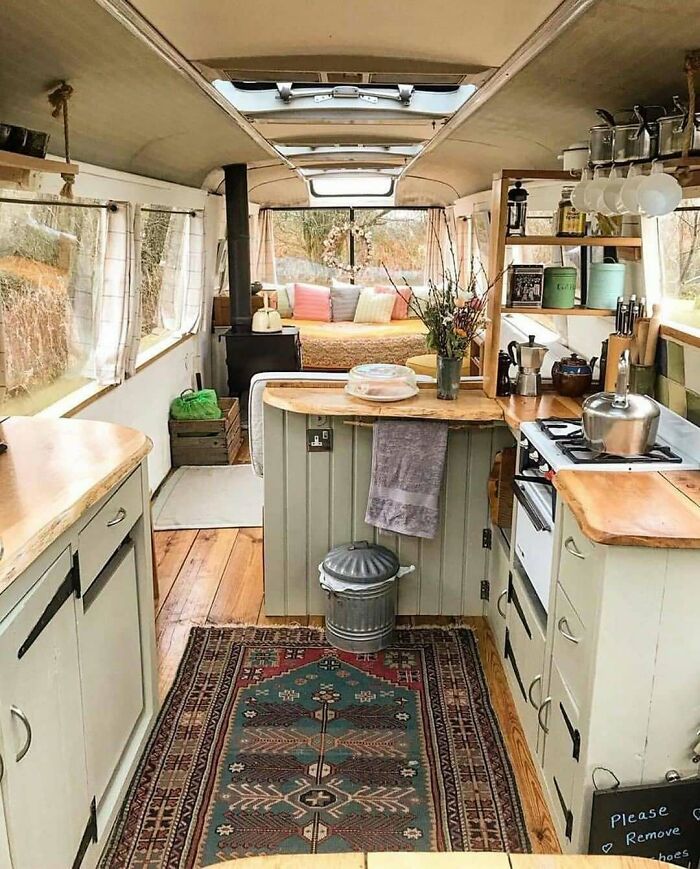 Cozy interior of a dreamy tiny home with a kitchen, living area, and wooden decor.