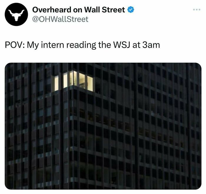 Office building at night with one lit window. 