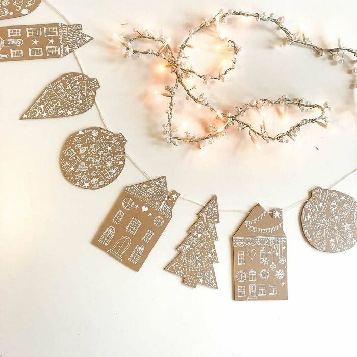 DIY Christmas decorations with etched cardstock ornaments and string lights.