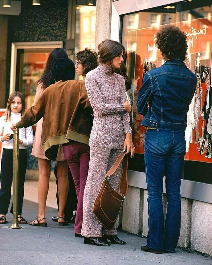 70s West Coast fashion scene with people in vintage attire outside a store, showcasing the iconic style of the era.