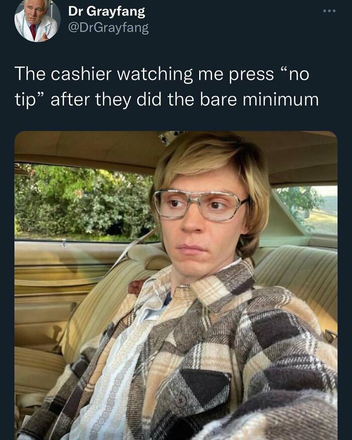 Man in glasses and plaid shirt with blank stare, representing a funny meme moment about tipping.