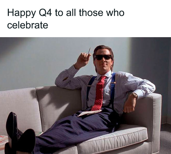 Man in suit and sunglasses relaxes on a sofa with "Happy Q4" text, showcasing investment meme humor.