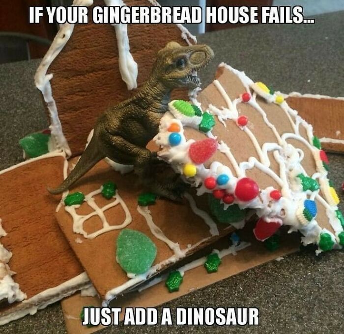 Dinosaur figurine amid gingerbread house pieces, humorously suggesting repair with prehistoric flair.
