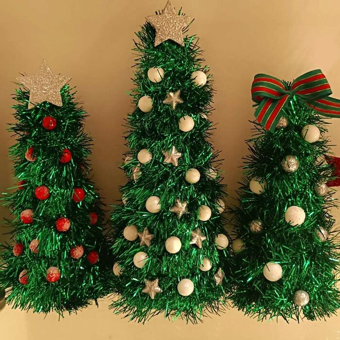 Three creative DIY Christmas decorations made from green tinsel, red ornaments, and silver stars with a bow.