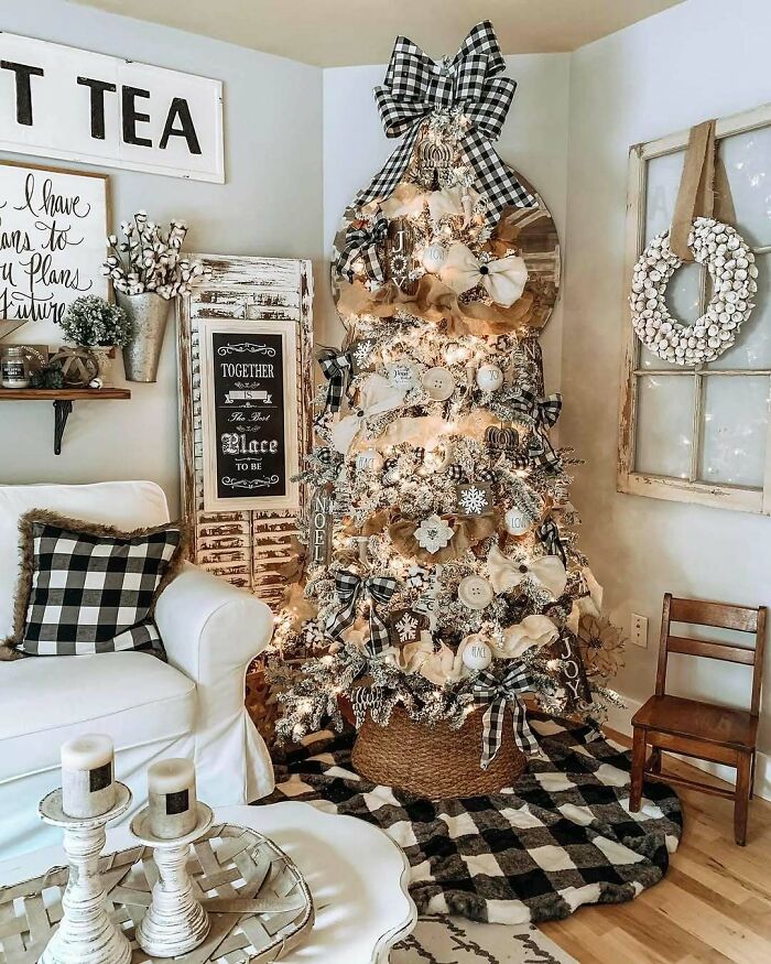 Rustic Christmas tree with plaid ribbons and ornaments in a cozy living room setting.