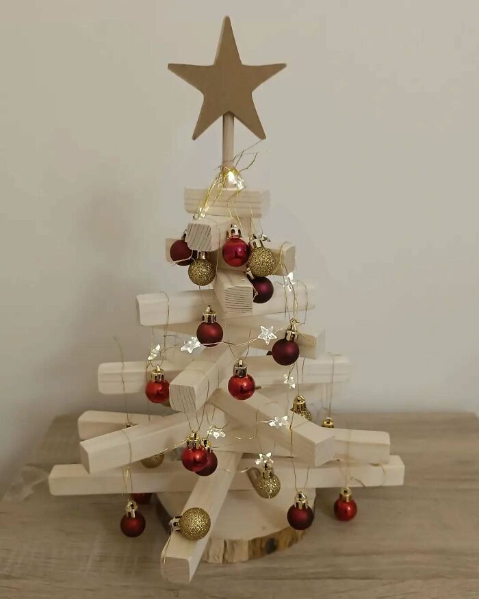 Wooden Christmas tree idea with red and gold baubles, topped with a star.