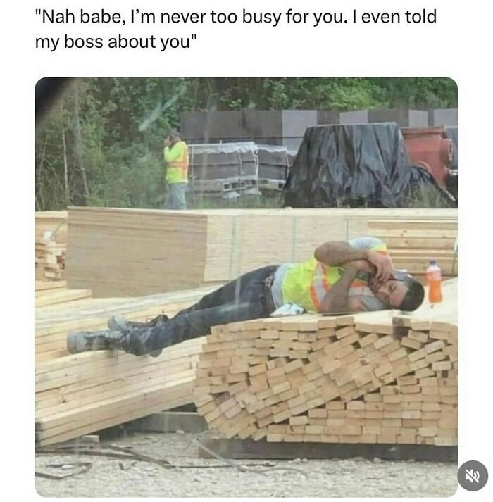 Construction worker lying on lumber pile, texting on phone, exemplifying worst funny fails in a job setting.