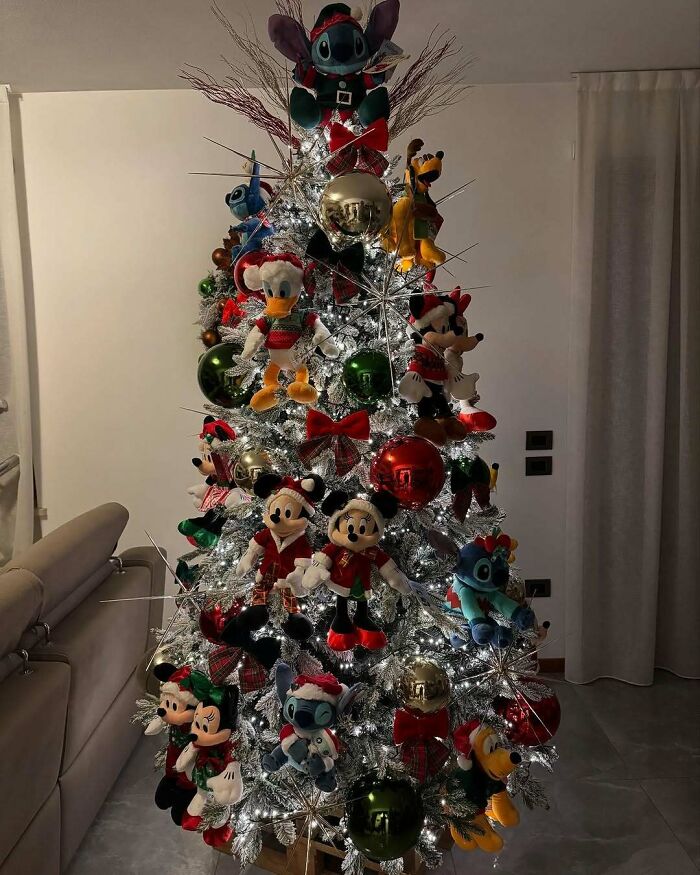 Christmas tree decorated with Disney plush toys and ornaments, showcasing a unique Christmas-tree idea.