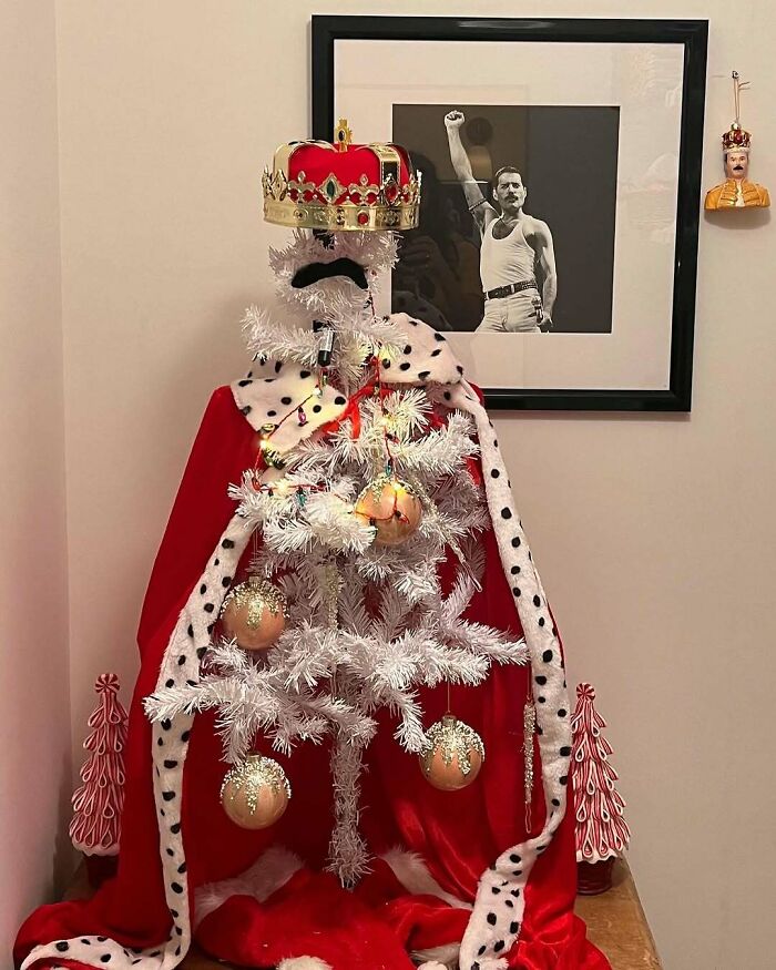 Creative Christmas tree decorated with a crown and cape, resembling a royal figure.