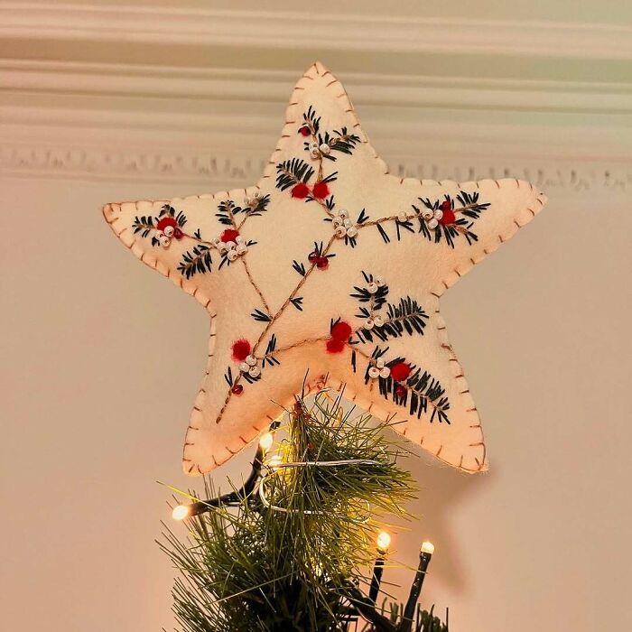 Handmade star tree topper with embroidered holiday patterns for creative DIY Christmas decorations.