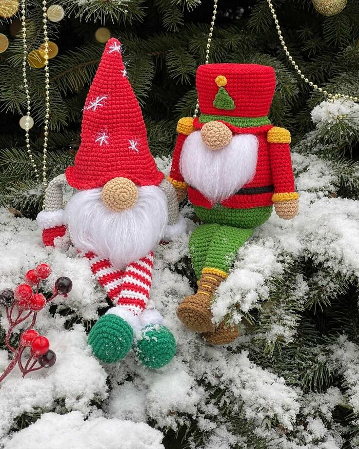 Handcrafted gnome decorations made for creative DIY Christmas adornments, displayed on a snowy tree branch.