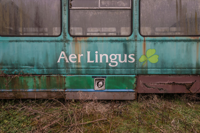 Rusty Irish ghost bus with Aer Lingus logo in graveyard.