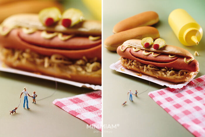 Miniature figures walking a dog near a large hot dog with mustard and olives, showcasing tiny world foods and creativity.