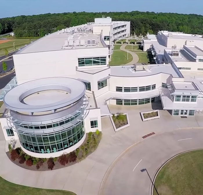 Aerial view of Dr. Phinnize J Fisher Middle School in Greenville County, South Carolina surrounded by greenery and winding pathways. Aerial view of Dr. Phinnize J Fisher Middle School in Greenville County, South Carolina surrounded by greenery and winding pathways.