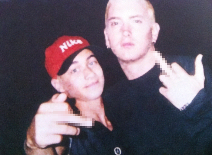 Two men posing together, one wearing a red cap, expressing emotions after mother's passing due to cancer.