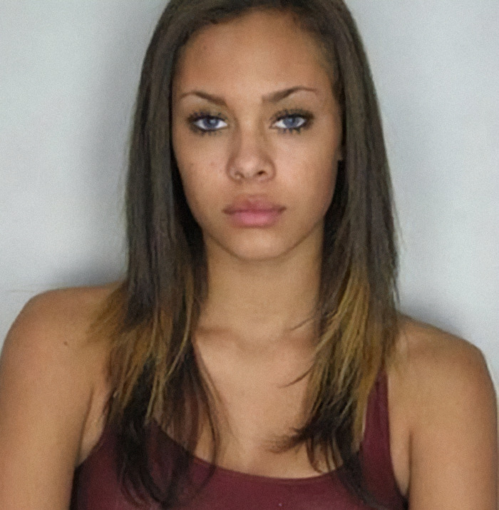 Viral mugshot of Gabrielle Hill with long hair and a serious expression.