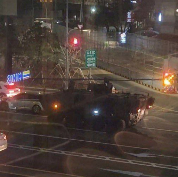 Military vehicle at night in South Korea after martial law declaration was rejected by parliament. Military vehicle at night in South Korea after martial law declaration was rejected by parliament.