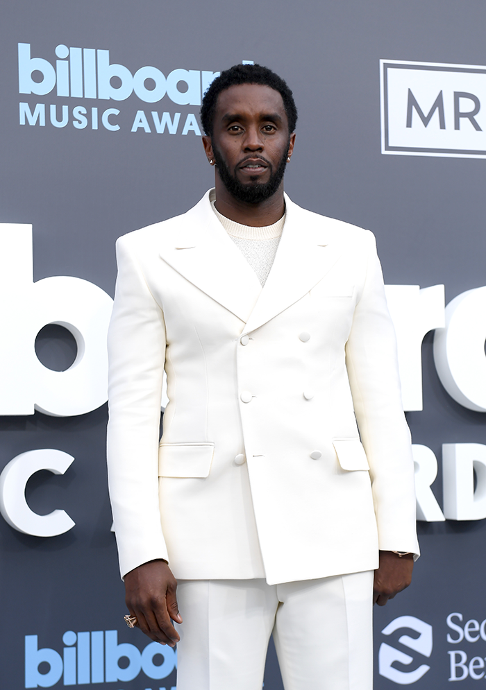 Diddy in a white suit at the Billboard Music Awards backdrop. Diddy in a white suit at the Billboard Music Awards backdrop.