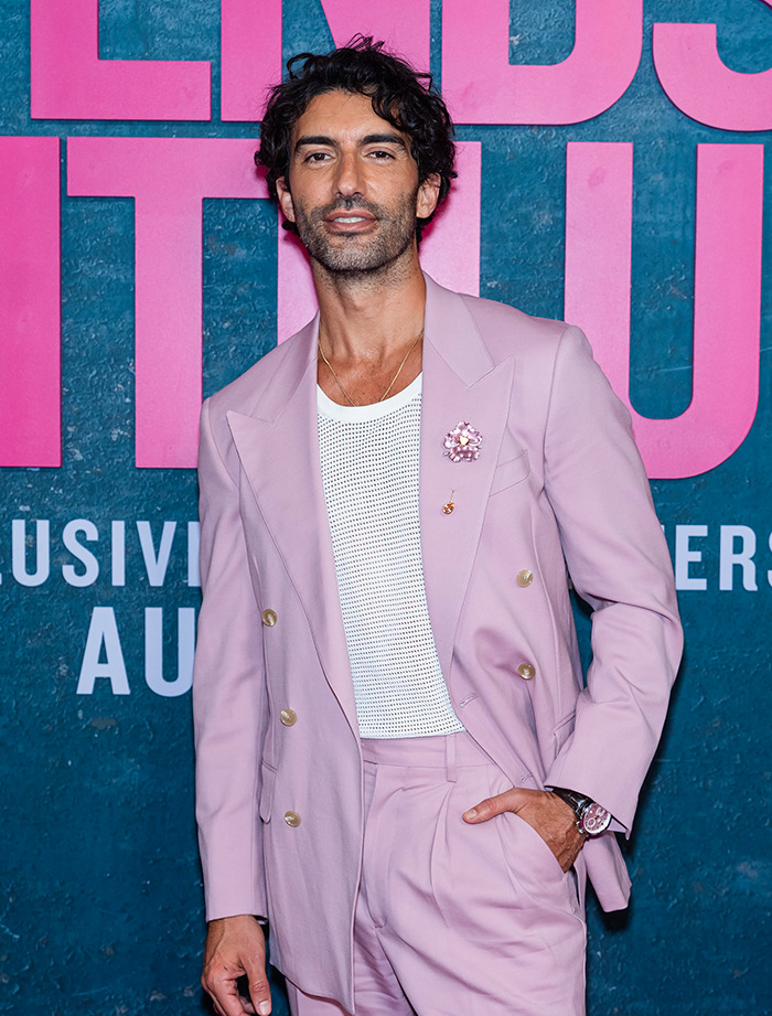 Justin Baldoni in a stylish pink suit at a public event. Justin Baldoni in a stylish pink suit at a public event.