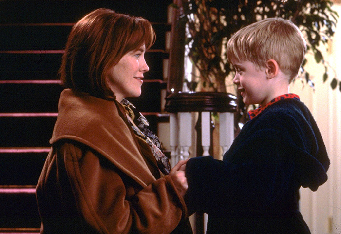 Kevin McCallister and his mom smiling at each other in a large, cozy home, sparking mansion affordability theories among fans.