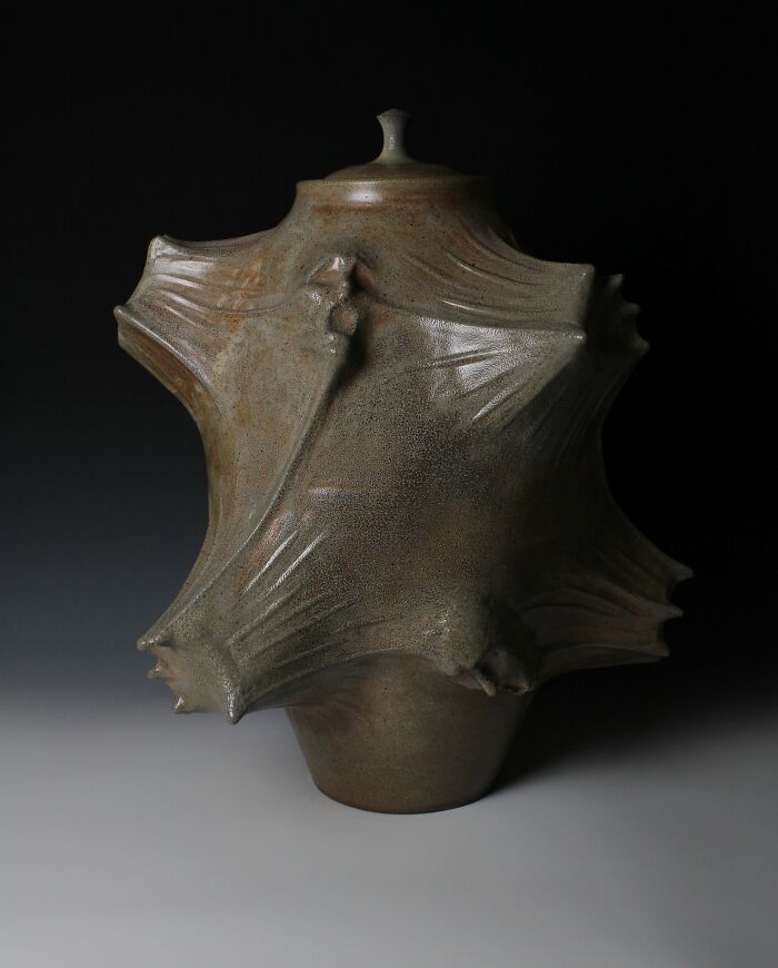 Surreal ceramic art piece with abstract textures and draped appearance by Jackson Shaner.