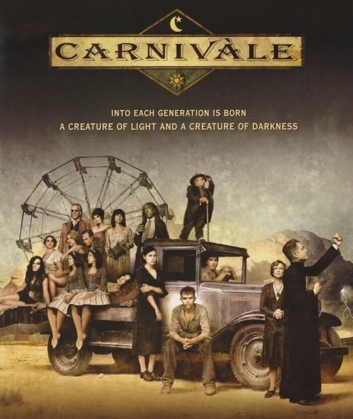 Poster of the TV show "Carnivàle," featuring the cast posing around an antique truck under a Ferris wheel.