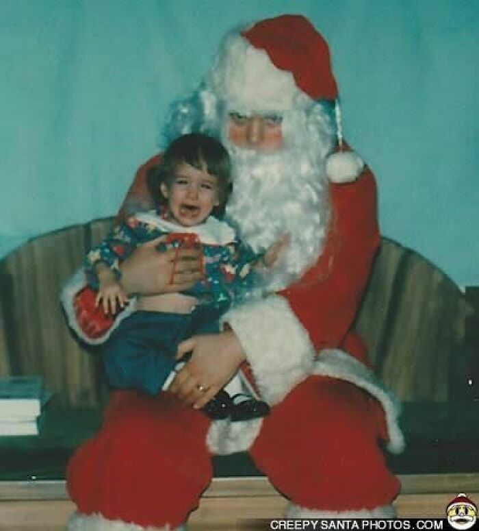 Creepy Santa holding a crying child in an unsettling holiday scene.