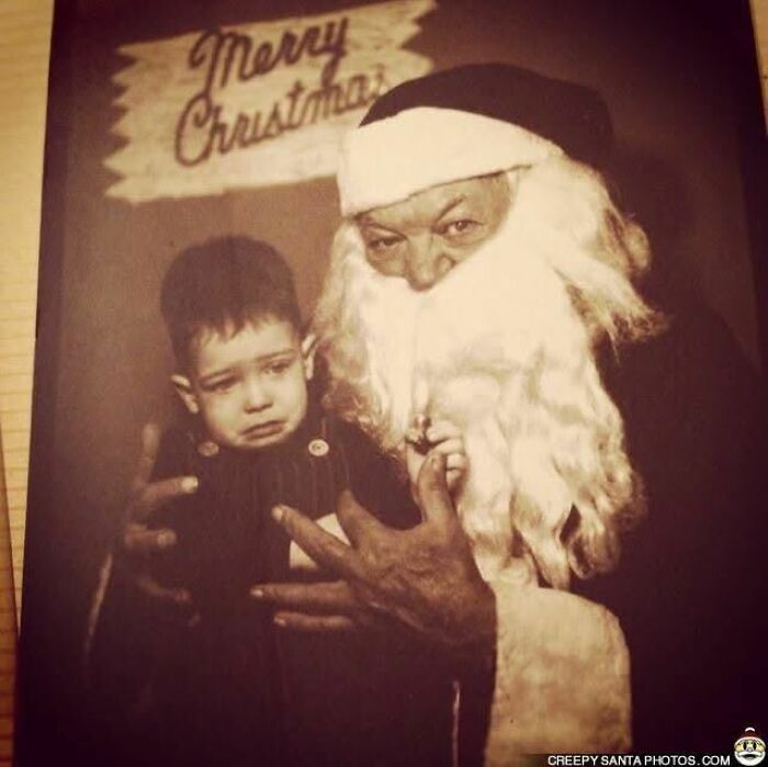 A child nervously sits on a creepy Santa's lap, with a "Merry Christmas" sign in the background.