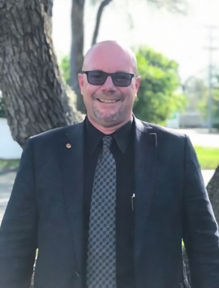 Briana Boston's attorney Jim Headley in suit with sunglasses outdoors. Briana Boston's attorney Jim Headley in suit with sunglasses outdoors.