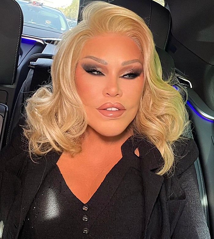 Catwoman Jocelyn Wildenstein, 84, with smooth skin, sitting in a car wearing a black outfit in Paris.