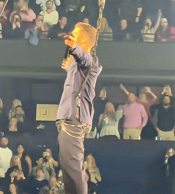 Justin Timberlake performing on stage in front of a cheering crowd, experiencing a wardrobe malfunction. Justin Timberlake performing on stage in front of a cheering crowd, experiencing a wardrobe malfunction.