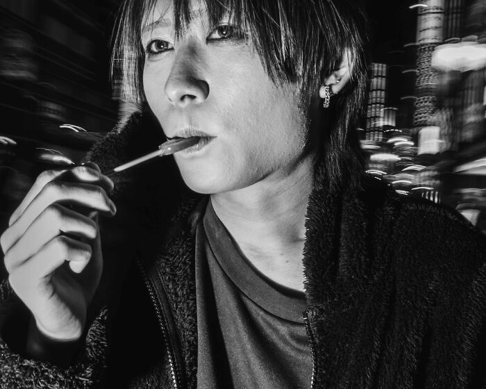 A person in Tokyo at night captures the essence of fast-paced urban life in this black and white photo by Ghawam Kouchaki.