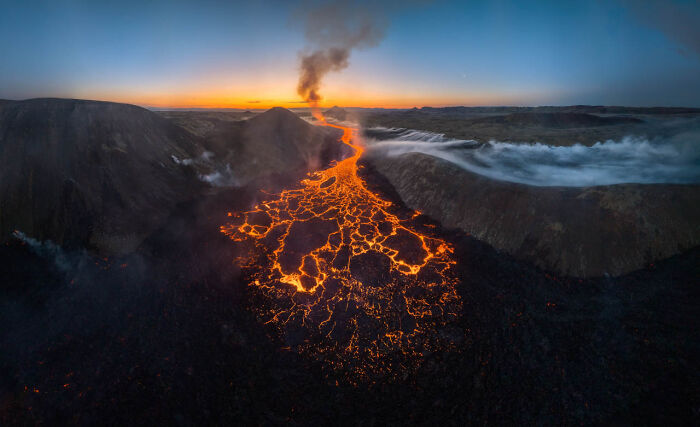 Lava flowing from a volcano at sunset, a winner from Nature Photographer of the Year 2024 Awards.